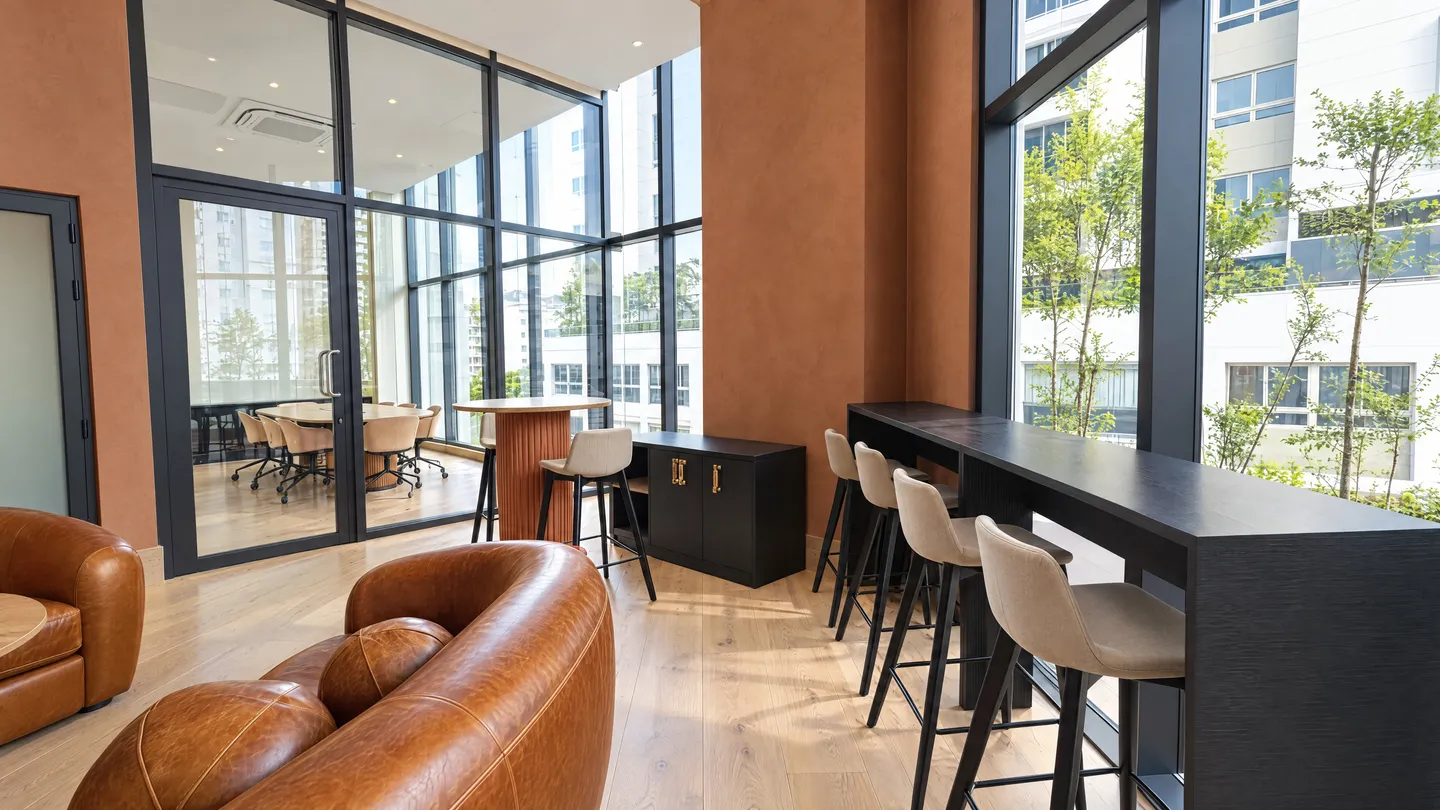 Coworking area with a high counter facing large windows
